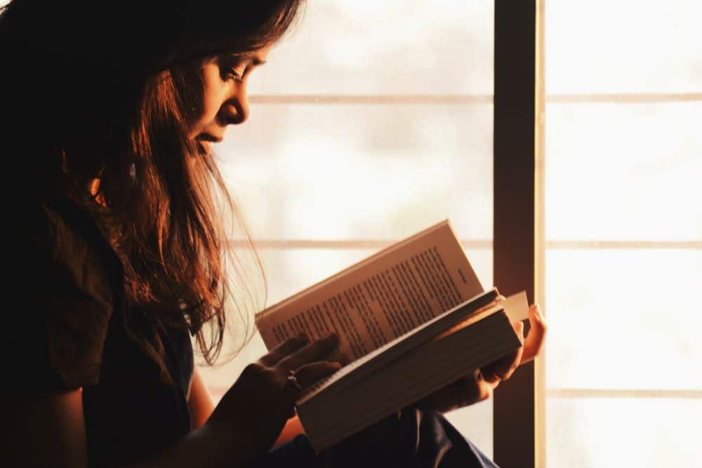 Lady acquiring self-knowledge from a book