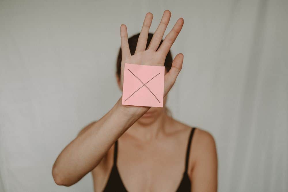 Girl with x covering her head representing internal conflicts
