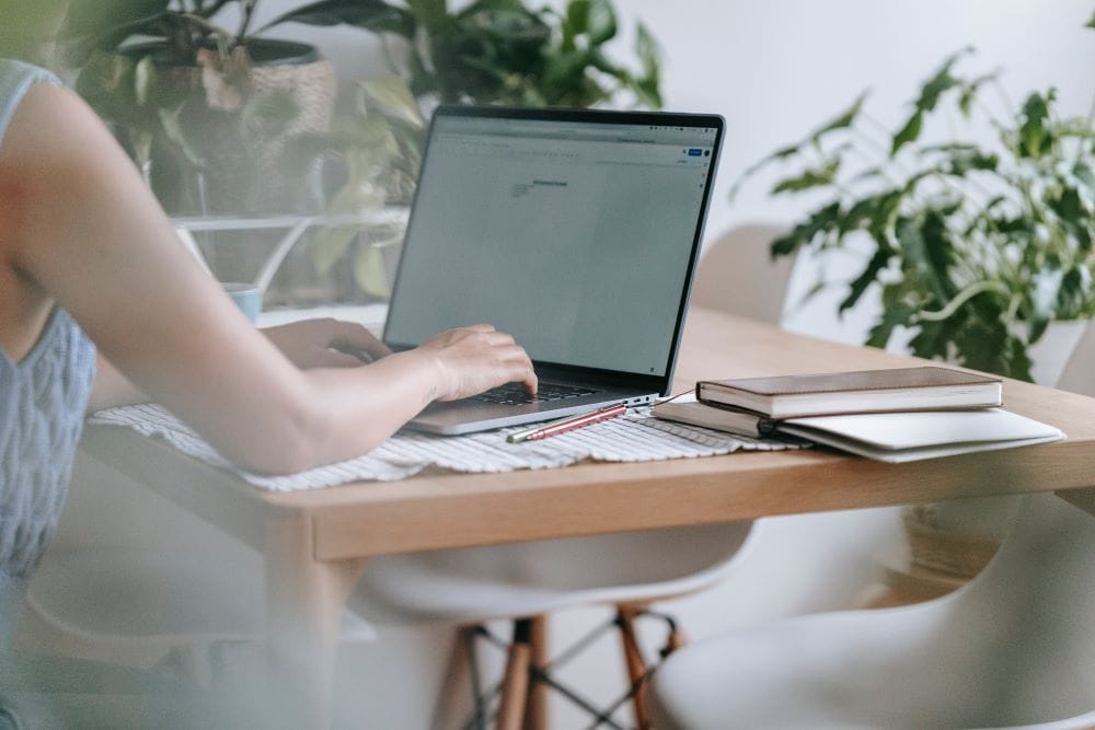 Woman working at her laptop, realizing her self's potential