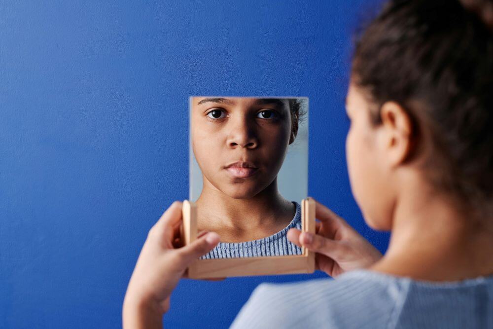 child looking in the mirror representing internal conflicts