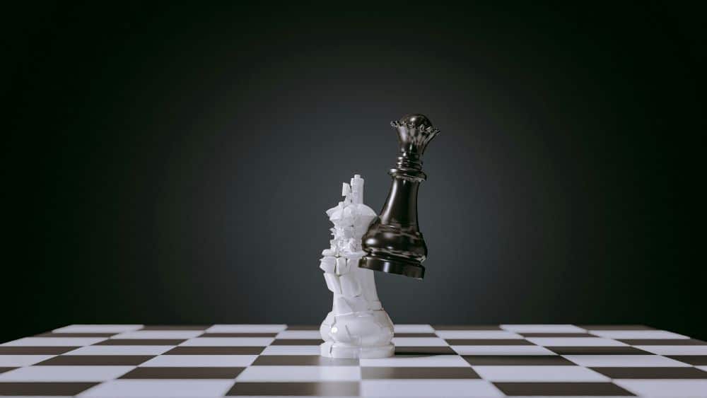 Chess pieces crashing together - symbolising ego defence mechanisms